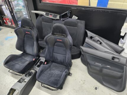 Mitsubishi Lancer Evolution VIII (Evo 8) MR, featuring black Alcantara and leather-trimmed Recaro bucket seats, matching rear seats, door cards, and center console components.