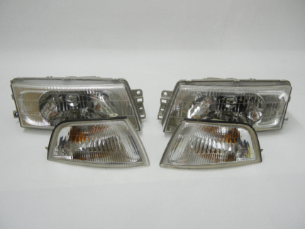 Set of front headlamp and corner turn signal light assemblies for a Mitsubishi Lancer CK4 / CK2 (1996–2000) sedan.