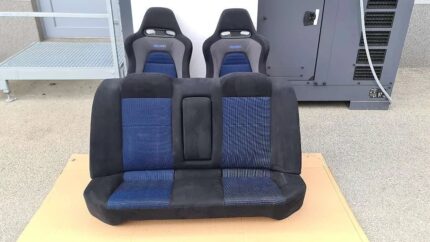 OEM blue and black Recaro front and rear interior seats from a Mitsubishi Lancer Evolution VII (CT9A), featuring blue mesh centers and black suede-like bolsters.