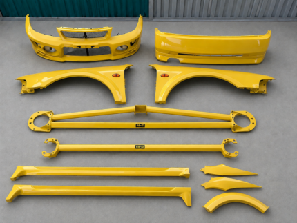 Vibrant yellow OEM Bodykits for lancer evo IV/V with front bumper assembly for a Mitsubishi Lancer Evolution V (CP9A), featuring integrated circular fog lights and mesh grilles.