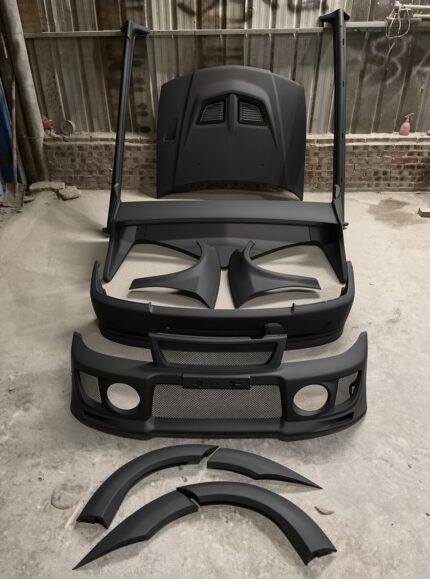 primer black, styled after the Mitsubishi Lancer Evolution V. It is used to convert or repair the exterior of a compatible Mitsubishi Lancer evo 4