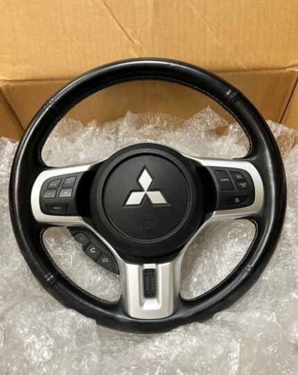 Genuine factory leather-wrapped steering wheel with integrated audio and cruise control switches from a Mitsubishi Lancer Evolution X